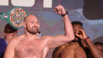 Britain's Tyson Fury (L) and Cameroonian-French Francis Ngannou react during their weigh-in on the eve of their bout in Riyadh on October 27, 2023. (Photo by Fayez NURELDINE / AFP)