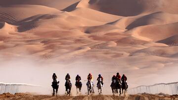 Jockeys compete in a race for purebred Arabian horses at the Liwa International Festival 2023, some 250 kilometres west of the Gulf Emirate of Abu Dhabi, on December 23, 2022. (Photo by Karim SAHIB / AFP)