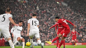Liverpool's Dutch striker #18 Cody Gakpo (L) shoots the ball and scores his team third goal during the English League Cup quarter-final football match between Liverpool and West Ham United at Anfield in Liverpool, north west England on December 20, 2023. (Photo by Oli SCARFF / AFP) / RESTRICTED TO EDITORIAL USE. No use with unauthorized audio, video, data, fixture lists, club/league logos or 'live' services. Online in-match use limited to 120 images. An additional 40 images may be used in extra time. No video emulation. Social media in-match use limited to 120 images. An additional 40 images may be used in extra time. No use in betting publications, games or single club/league/player publications. /