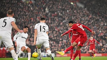 Liverpool's Dutch striker #18 Cody Gakpo (L) shoots the ball and scores his team third goal during the English League Cup quarter-final football match between Liverpool and West Ham United at Anfield in Liverpool, north west England on December 20, 2023. (Photo by Oli SCARFF / AFP) / RESTRICTED TO EDITORIAL USE. No use with unauthorized audio, video, data, fixture lists, club/league logos or 'live' services. Online in-match use limited to 120 images. An additional 40 images may be used in extra time. No video emulation. Social media in-match use limited to 120 images. An additional 40 images may be used in extra time. No use in betting publications, games or single club/league/player publications. / 