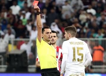 Real Madrid's Federico Valverde is shown a red card by the referee