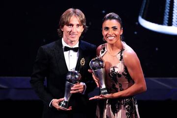 Luka Modric of Real Madrid (left) and Marta of Orlando Pride pose with their Best Player trophies.