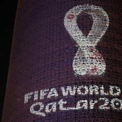 What is the official logo for the 2022 Qatar World Cup and who designed it?