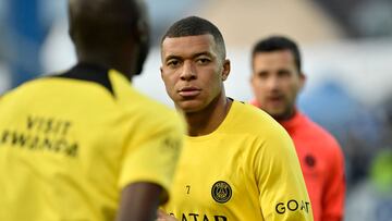 (FILES) Paris Saint-Germain's French forward Kylian Mbappe looks on as he warms up before the French L1 football match between AJ Auxerre and Paris Saint-Germain (PSG) at Stade de l'Abbe-Deschamps in Auxerre, central France, on May 21, 2023. Kylian Mbappe is not on the list of PSG players who will take part in the Japan Tour 2023 according to the list published by the club on July 21, 2023. (Photo by Julien DE ROSA / AFP)