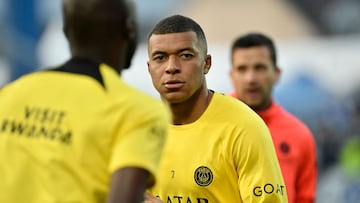 (FILES) Paris Saint-Germain's French forward Kylian Mbappe looks on as he warms up before the French L1 football match between AJ Auxerre and Paris Saint-Germain (PSG) at Stade de l'Abbe-Deschamps in Auxerre, central France, on May 21, 2023. Kylian Mbappe is not on the list of PSG players who will take part in the Japan Tour 2023 according to the list published by the club on July 21, 2023. (Photo by Julien DE ROSA / AFP)