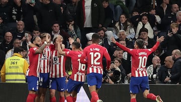 Atletico Madrid's Spanish midfielder #14 Marcos Llorente (2nd-R) celebrates with teammates after scoring his team's first goal during the Spanish league football match between Real Madrid CF and Club Atletico de Madrid at the Santiago Bernabeu stadium in Madrid on February 4, 2024. (Photo by Thomas COEX / AFP)