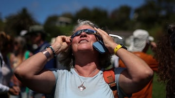 A visitor tests special protective glasses to observe the upcoming solar eclipse at Hanga Piko archaeological monument area at Rapa Nui national park managed by the Mau Henua native community at Easter Island, Chile October 1, 2024. REUTERS/Ivan Alvarado