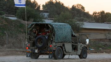 Israeli soldiers ride inside a military vehicle, amid a temporary truce between Hamas and Israel, near Gaza, in South Israel, November 30, 2023. REUTERS/Alexander Ermochenko