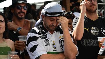Botafogo supporters react as they watch on a screen the 2024 FIFA Intercontinental Cup football match between Brazil's Botafogo and Mexico's Pachuca at the historical headquarters of Botafogo, named General Severiano, in Rio de Janeiro, Brazil, on December 11, 2024. (Photo by Mauro PIMENTEL / AFP)