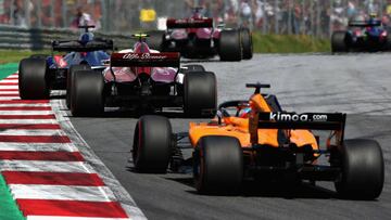 SPIELBERG, AUSTRIA - JULY 01: Charles Leclerc of Monaco driving the (16) Alfa Romeo Sauber F1 Team C37 Ferrari leads Fernando Alonso of Spain driving the (14) McLaren F1 Team MCL33 Renault on track during the Formula One Grand Prix of Austria at Red Bull 