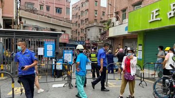 Security guards stand at an entrance to Wanxia urban village, which has been closed as part of coronavirus disease (COVID-19) control measures in Shenzhen, Guangdong province, China August 29, 2022. REUTERS/David Kirton