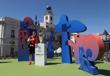 Soccer Football - Champions League Final - The 2019 trophy arrives in Madrid - Madrid, Spain - May 30, 2019   A Liverpool fan poses with the trophy  