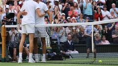 Italy's Jannik Sinner (L) and Spain's Carlos Alcaraz hug each other after their round of 16 men's singles tennis match on the seventh day of the 2022 Wimbledon Championships at The All England Tennis Club in Wimbledon, southwest London, on July 3, 2022. (Photo by Adrian DENNIS / AFP) / RESTRICTED TO EDITORIAL USE