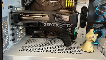 Close-up of an Nvidia GeForce RTX 4060 seated in a custom PC build, illuminated by RGB lighting.