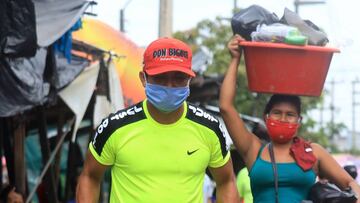 IQUITOS, PERU - APRIL 27: A man  wearing a face mask carries coal in a trolley at Iquitos Modelo Market during COVID-19 pandemic on April 27, 2020 in Iquitos, Peru. Iquitos, capital city  of the largest region of Peru, is about to collapse due to the increasing number of cases of COVID-19 in the region.  (Photo by Getty Images/Getty Images)