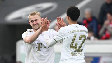 FREIBURG IM BREISGAU, GERMANY - APRIL 08: Matthijs de Ligt of Bayern Munich celebrates with team mate Jamal Musiala after scoring their sides first goal during the Bundesliga match between Sport-Club Freiburg and FC Bayern München at Europa-Park Stadion on April 08, 2023 in Freiburg im Breisgau, Germany. (Photo by Matthias Hangst/Getty Images)