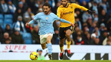 MANCHESTER, ENGLAND - JANUARY 22:   Bernardo Silva of Manchester City competes with Rayan Ait Nouri of Wolverhampton Wanderers during the Premier League match between Manchester City and Wolverhampton Wanderers at Etihad Stadium on January 22, 2023 in Manchester, United Kingdom. (Photo by Chris Brunskill/Fantasista/Getty Images)