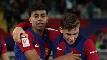 Barcelona's Spanish forward #27 Lamine Yamal (L) celebrates with Barcelona's Spanish midfielder #16 Fermin Lopez after scoring his team's first goal during the Spanish league football match between FC Barcelona and RCD Mallorca at the Estadi Olimpic Lluis Companys in Barcelona on March 8, 2024. (Photo by LLUIS GENE / AFP)