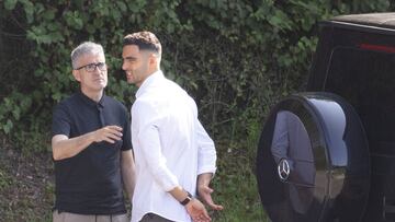 SAN SEBASTIÁN, 23/08/2024.- El ya ex jugador de la Real Sociedad, Mikel Merino (d), conversa con el director deportivo de club, Roberto Olabe, tras despedirse de sus compañeros este viernes en el campo de entrenamiento de Zubieta, en San Sebastián. La Real Sociedad y el Arsenal han alcanzado este jueves un acuerdo para el traspaso del centrocampista navarro Mikel Merino al club londinense por 32,5 millones de euros y 5 millones más en variables.EFE/Javier Etxezarreta