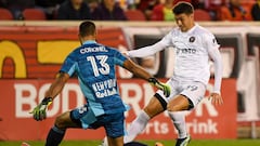 Oct 9, 2021; Harrison, New Jersey, USA;  New York Red Bulls goalkeeper Carlos Miguel Coronel (13) makes a save n Inter Miami forward Robbie Robinson (19) during the first half at Red Bull Arena. Mandatory Credit: Dennis Schneidler-USA TODAY Sports