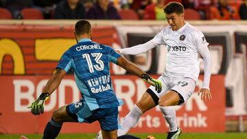 Oct 9, 2021; Harrison, New Jersey, USA; New York Red Bulls goalkeeper Carlos Miguel Coronel (13) makes a save n Inter Miami forward Robbie Robinson (19) during the first half at Red Bull Arena. Mandatory Credit: Dennis Schneidler-USA TODAY Sports