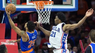 Jan 11, 2017; Philadelphia, PA, USA; New York Knicks guard Derrick Rose (25) scores past Philadelphia 76ers center Joel Embiid (21) during the second half at Wells Fargo Center. The Philadelphia 76ers won 98-97. Mandatory Credit: Bill Streicher-USA TODAY Sports