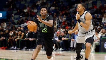 Derik Queen #22 of the New Orleans Pelicans is defended by Keldon Johnson #3 of the San Antonio Spurs during the second half of a game at Smoothie King Center on December 08, 2025 in New Orleans, Louisiana.