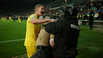 The Ukrainian captain tried (unsuccessfully) to prevent security from taking a fan off the field after they beat Iceland 2-1 in the Euro 2024 playoff match.