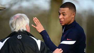 France's forward Kylian Mbappe (R) reacts ahead of a training session in Clairefontaine-en-Yvelines, near Paris on March 21, 2022 ahead of the friendly matches against Ivory Coast and South Africa. (Photo by FRANCK FIFE / AFP)