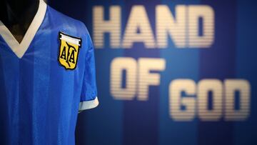 (FILES) In this file photo taken on April 20, 2022 a football shirt worn by Argentina's Diego Maradona during the 1986 World Cup quarter-final match against England, is pictured during a photocall at Sotheby's auction house in London ahead of its sale. - The jersey that Argentina football legend Diego Maradona wore when scoring twice against England in the 1986 World Cup, including the infamous "hand of God" goal, was auctioned for $9.3 million, a record for any item of sports memorabilia, Sotheby's said May 4, 2022. (Photo by ADRIAN DENNIS / AFP)