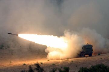 U.S. Marine Corps Marines, Tango Battery, 5th Battalion, 11th Marine Regiment, 1st Marine Division, fire a Multiple Launch Rocket System Family of Munitions (MFOR) rocket from a High Mobility Artillery Rocket System (HIMARS) launcher at Camp Pendleton, Calif., on June 1, 2007.  The HIMARS system consists of one launcher, two re-supply vehicles, two re-supply trailers and a basic load of nine pods (six rockets per pod) of MFOR rockets.  (U.S. Marine Corps photo by Lance Cpl. Seth Maggard) (Released)