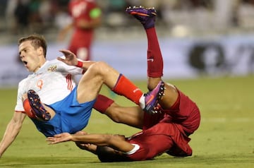 Qatar's Pedro Miguel and Russia's Aleksandr Kokorin fall in their recent international friendly.