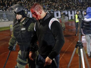 CORRECTION - A policeman arrests a Partizan Belgrade&#039;s hooligan after clashes between two groups of Partizan Belgrade&#039;s supporters during the Serbian Superleague derby football match between Partizan Belgrade and Crvena Zvezda (Red Star), on December 13, 2017 in Belgrade. / AFP PHOTO / PEDJA MILOSAVLJEVIC / The erroneous mention appearing in the metadata of this photo by PEDJA MILOSAVLJEVIC has been modified in AFP systems in the following manner: [Policemen evacuate Partizan Belgrade&#039;s hooligans after clashes between two groups of Partizan Belgrade&#039;s supporters] instead of [Policemen evacuate Red star Belgrade&#039;s and Partizan Belgrade&#039;s hooligans after clashes]. Please immediately remove the erroneous mention[s] from all your online services and delete it from your servers. If you have been authorized by AFP to distribute it to third parties, please ensure that the same actions are carried out by them. Failure to promptly comply with these instructions will entail liability on your part for any continued or post notification usage. Therefore we thank you very much for all your attention and prompt action. We are sorry for the inconvenience this notification may cause and remain at your disposal for any further information you may require.