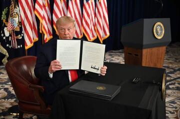 US President Donald Trump signs executive orders extending coronavirus economic relief, during a news conference in Bedminster, New Jersey, on August 8, 2020.