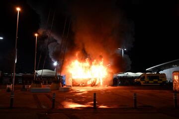 Flames engulf a merchandise stall outside of the Etihad Stadium in Manchester, north west England, on January 29, 2025, ahead of the UEFA Champions League football match between Manchester City and Club Brugge. (Photo by Paul ELLIS / AFP)