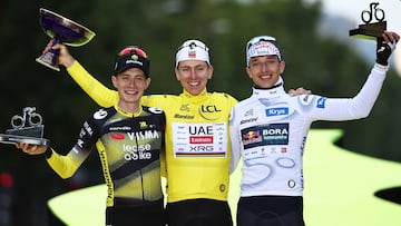 Overall winner UAE Team Emirates - XRG team's Slovenian rider Tadej Pogacar (C) wearing the overall leader's yellow jersey, second-placed Team Visma - Lease a bike team's Danish rider Jonas Vingegaard (L), and third-placed Red Bull - BORA - hansgrohe team's German rider Florian Lipowitz (R) celebrate on the podium after the 21st and final stage of the 112th edition of the Tour de France cycling race, 132.3 km between Mantes-la-Ville and Paris Champs-�lysees, on July 27, 2025. (Photo by Anne-Christine POUJOULAT / AFP)