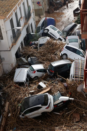 Los coches se amontonan en una calle tras las lluvias torrenciales que provocaron inundaciones, en Paiporta, Valencia.