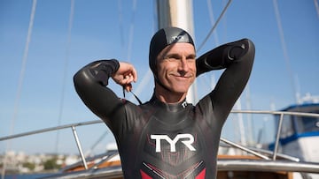 In this undated image released by the Ben Lecomte group A.K.K The Longest Swim, Ben Lecomte adjusts his suit during swimming practices in Los Angeles, California. Lecomte set off Tuesday from Japan in an attempt to become the first person to swim across t