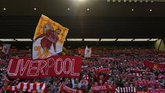 Liverpool fans wave flags in the crowd during the English Premier League football match between Liverpool and Wolverhampton Wanderers at Anfield in Liverpool, north west England on May 12, 2019. (Photo by Paul ELLIS / AFP) / RESTRICTED TO EDITORIAL USE. N