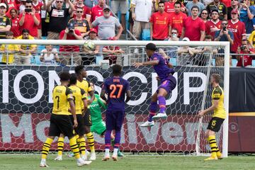 Liverpool's Virgil van Dijk (2nd R) scores a goal from a header on Borussia Dortmund's goalkeeper Marwin Hitz during the 2018 International Champions Cup at Bank of America Stadium in Charlotte, North Carolina, on July 22, 2018.  / AFP PHOTO / JIM WATSON