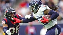 HOUSTON, TEXAS - OCTOBER 30: Derrick Henry #22 of the Tennessee Titans runs with the ball as Jonathan Owens #36 of the Houston Texans defends during the first quarter at NRG Stadium on October 30, 2022 in Houston, Texas.   Carmen Mandato/Getty Images/AFP