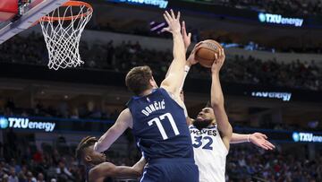 Mar 21, 2022; Dallas, Texas, USA; Minnesota Timberwolves center Karl-Anthony Towns (32) shoots over Dallas Mavericks guard Luka Doncic (77) during the second half at American Airlines Center. Mandatory Credit: Kevin Jairaj-USA TODAY Sports