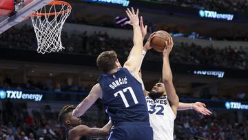 Mar 21, 2022; Dallas, Texas, USA;  Minnesota Timberwolves center Karl-Anthony Towns (32) shoots over Dallas Mavericks guard Luka Doncic (77) during the second half at American Airlines Center. Mandatory Credit: Kevin Jairaj-USA TODAY Sports