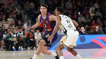 Barcelona's Italian guard #02 Dame Sarr fights for the ball with Villeurbanne's French guard #16 Mehdy Ngouama during their Euroleague Basketball match between FC Barcelona and Asvel Lyon Villeurnes at the Palau Blaugrana in Barcelona, Spain, on November 26, 2025. (Photo by Lluis GENE / AFP)