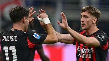 AC Milan's Begian midfielder #56 Alexis Saelemaekers (R) celebrates with his teammate AC Milan's US forward #11 Christian Pulisic after scoring his team's opening goal during the Italian Serie A football match between AC Milan and SSC Napoli at San Siro stadium in Milan, northern Italy, on September 28, 2025. (Photo by Piero CRUCIATTI / AFP)