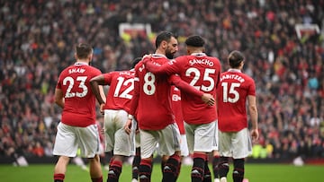 Manchester United's Portuguese midfielder Bruno Fernandes celebrates with Manchester United's English striker Jadon Sancho after scoring his team first goal during the English Premier League football match between Manchester United and Aston Villa at Old Trafford in Manchester, north west England, on April 30, 2023. (Photo by Oli SCARFF / AFP) / RESTRICTED TO EDITORIAL USE. No use with unauthorized audio, video, data, fixture lists, club/league logos or 'live' services. Online in-match use limited to 120 images. An additional 40 images may be used in extra time. No video emulation. Social media in-match use limited to 120 images. An additional 40 images may be used in extra time. No use in betting publications, games or single club/league/player publications. / 