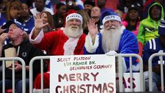 Atlanta Falcons and Indianapolis Colts fans hold up a Merry Christmas sign