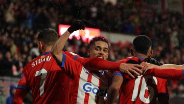 Girona's Brazilian midfielder #16 Savio Moreira celebrates with Girona's Brazilian defender #20 Yan Couto and Girona's Uruguayan forward #07 Cristhian Stuani after scoring his team's third goal during the Spanish league football match between Girona FC and Rayo Vallecano de Madrid at the Montilivi stadium in Girona on February 26, 2024. (Photo by LLUIS GENE / AFP)
