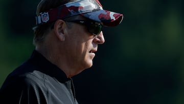 Washington Commanders defensive coordinator Jack Del Rio stands on the field during Commanders OTAs at The Park in Ashburn.