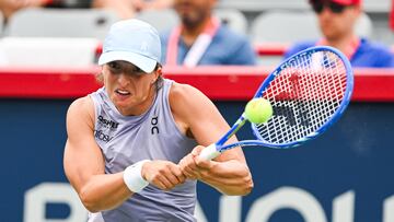 Jul 30, 2025; Montreal, QC, Canada; Iga Swiatek (POL) returns the ball to Hanyu Guo (CHN) in second round play at IGA Stadium. Mandatory Credit: David Kirouac-Imagn Images